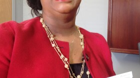 Providence House executive director Verni Howard holds a seed packet, a memento that will be handed out at Wednesday's dedication ceremony.