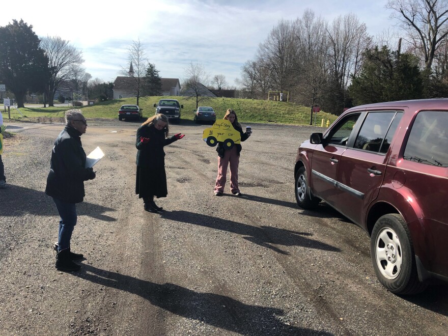 Lay ministers Darlene Washington (from left) and Jackie Waymire and Pastor Faith Wilkerson pray with a couple in the Centenary Methodist Church parking lot in Shady Side, Md.
