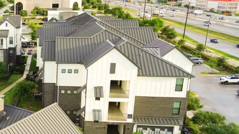 Swimming pool spa in new development apartment complex with metal roofing, siding near Interstate Highway I-35, fast growing area Pflugerville northeast of downtown Austin, Texas, housing marke