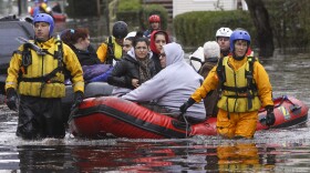 People are evacuated from a neighborhood in Little Ferry, New Jersey, one day after Hurricane Sandy slammed the East Coast on October 30, 2012. Officials in the states of Connecticut, Maryland, New York, New Jersey, North Carolina, Pennsylvania, Virginia and West Virginia all reported deaths from the massive storm system, while Toronto police said a Canadian woman was killed by flying debris.