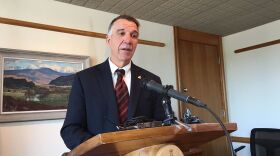 Gov. Phil Scott, addressing reporters from a podium at a press conference