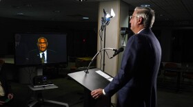 Due to COVID-19 precautions, the three gubernatorial candidates and the moderator were in separate rooms at WFYI studios in Indianapolis. Here, Republican Gov. Eric Holcomb watches Democrat Dr. Woody Myers speak.