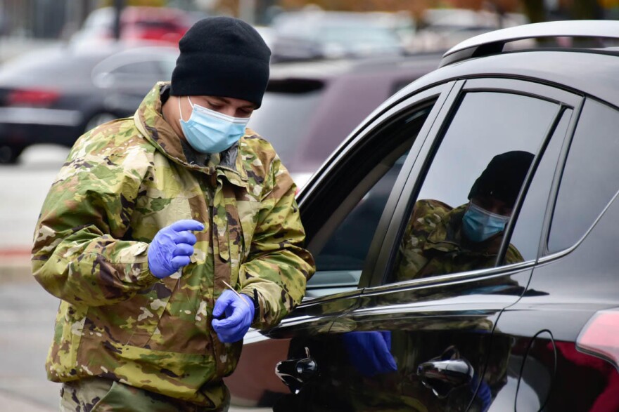 A National Guard member helps at a drive thru vaccination clinic in South Bend.