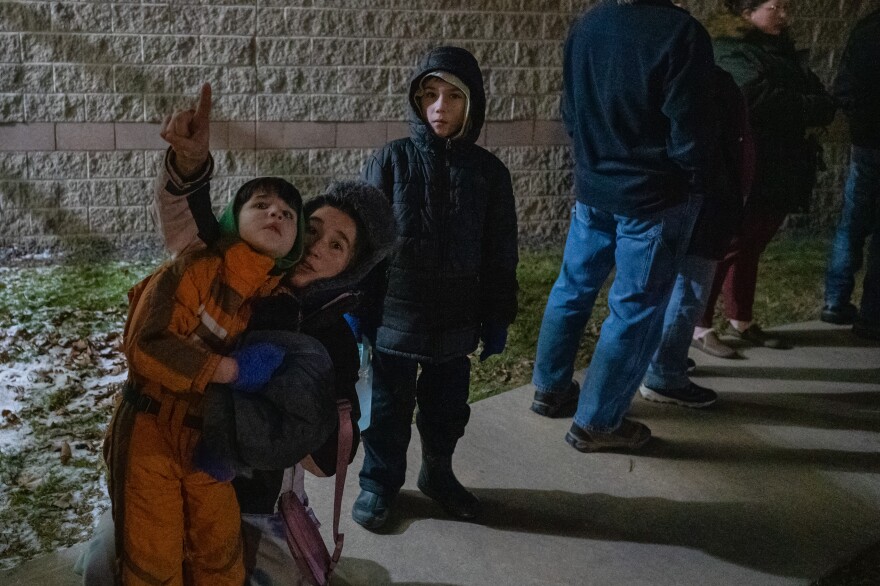 Michelle Regg, points to a constellation for Walter Proctor, 6, and Charlie Proctor, 9.