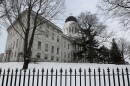 Snow covers the lawn outside the State House in Augusta, Maine, Wednesday, Jan. 8, 2020.