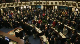 Floral arrangements decorate desks during a joint session Tuesday, March 4, 2014, on the floor of the House of Representatives at the Capitol in Tallahassee, Fla. The 2014 Florida legislative session starts today. (AP Photo/Phil Sears)