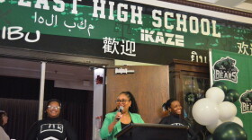 Superintendent Jennifer Collier celebrates East High School's centennial anniversary with a crowd of student, alumni and staff.