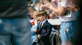 A boy carries a rose at a Vietnam Memorial Ceremony at the College of the Ozarks, near Branson.