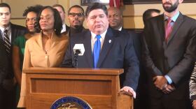 Gov. J.B. Pritzker (center) with Senate Sponsor Kimberly Lightford (left) and House Sponsor Will Guzzardi (right).