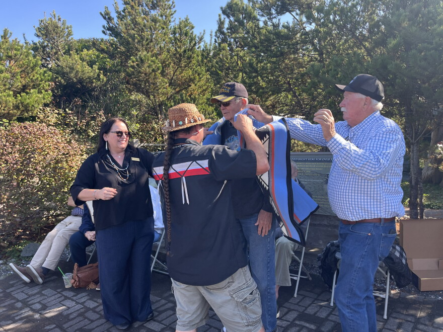 Tribal members present Port of Bandon Commissioner Don Starbuck with a blanket.