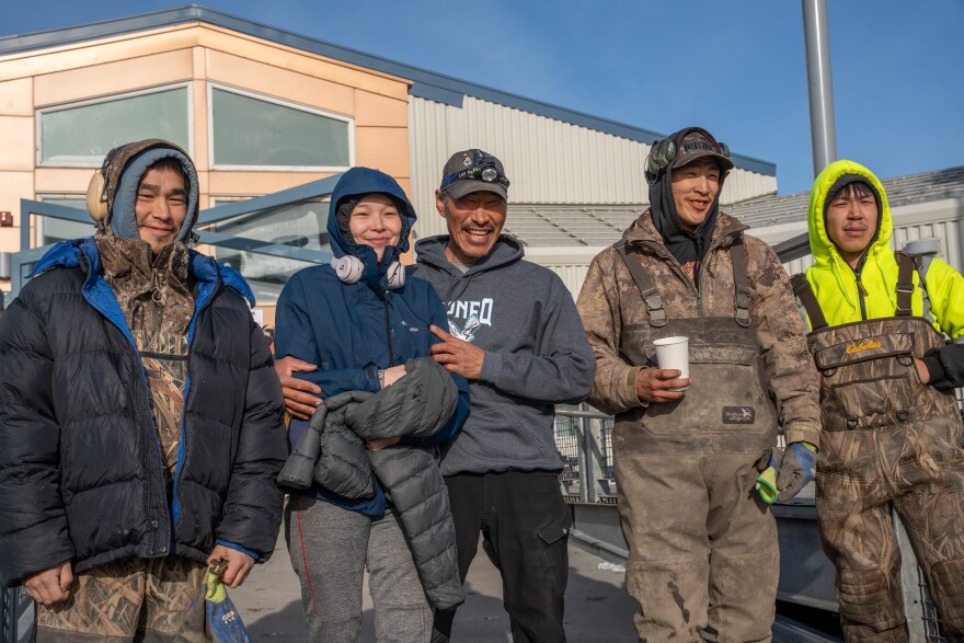 From left to right, Tony Paul, Anna Kashatok, Benjamin Kugtsun, Logan Paul and Joshua Dock stand outside the Chief Paul Memorial School in Kipnuk, Alaska on Oct. 19, 2025.