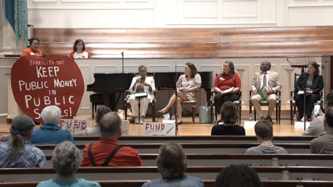 Guilford democratic representatives sit on stage at a town hall about public school funding