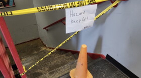 A stairwell leading to a Bloomington fire department's flooded basement is taped off after a severe thunderstorm and flash flood.