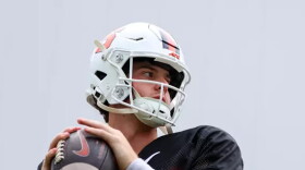 Quarterback Steve Angeli (9, Black) readies to throw in a preseason practice.