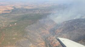 An aerial view shows smoke and burned canyon country along the Dolores River during the Ferris Fire. River advocates say the fire could affect old-growth ponderosa pines, native fish habitat, recreation access and post-fire erosion in the canyon.