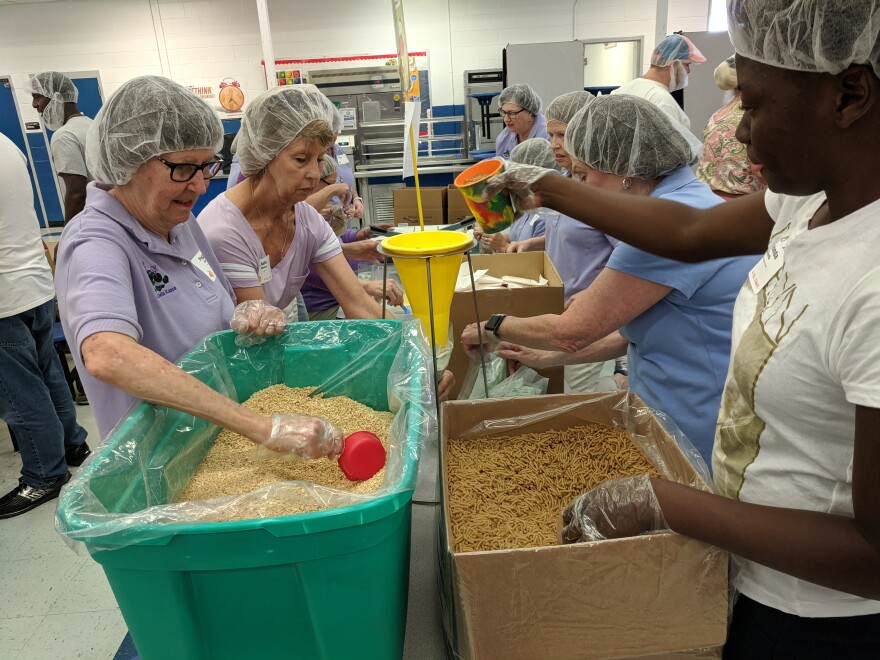 Churches and other volunteer groups spent Saturday morning packing thousands of meal pouches at Godby's cafeteria.