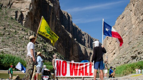 Terlingua resident John Rakowitz waves an anti-border wall version of the Gadsden flag that reads “Don’t tread on Big Bend. We do not need the wall.”