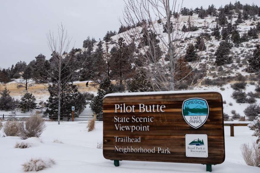 A person hikes up Pilot Butte in Bend, Ore., Friday, Feb. 12, 2021, after a day's snowfall.