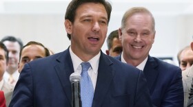 Surrounded by lawmakers, Florida Gov.Ron DeSantis speaks at the end of a legislative session, Friday, April 30, 2021, at the Capitol in Tallahassee, Fla.