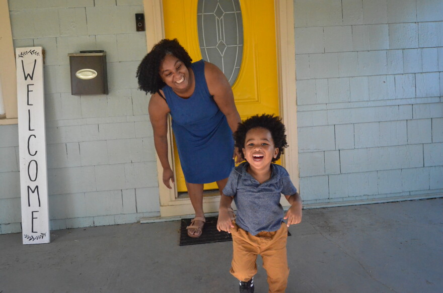 Destiny Abercrombie and her youngest son walk on their porch in Kansas City, Missouri. Abercrombie gave birth to her youngest at home unassisted.