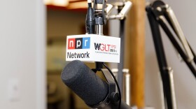 A microphone hangs in a radio studio