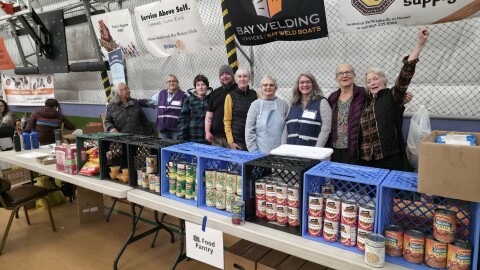 Volunteers staff the food pantry table at Homer’s Community Resource Connect on Tuesday, Jan. 27, 2026 in Homer, Alaska. The annual event brings together dozens of agencies to offer medical care, supplies and housing support.