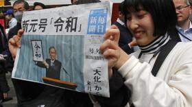 A woman holds a copy of the Mainichi Shimbun newspaper reporting the name of new era “Reiwa," unveiled in Tokyo, Monday, April 1, 2019. (Koji Sasahara/AP)