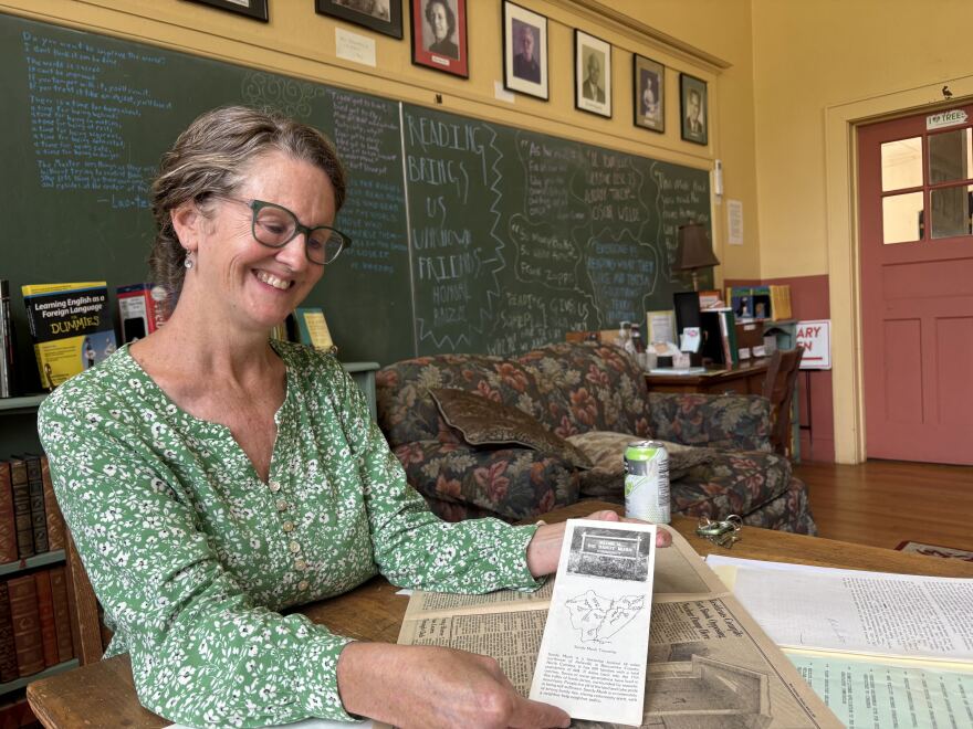 Terri Wells shows a brochure created by local women in Sandy Mush for the 1980s anti-nuclear waste dump campaign.