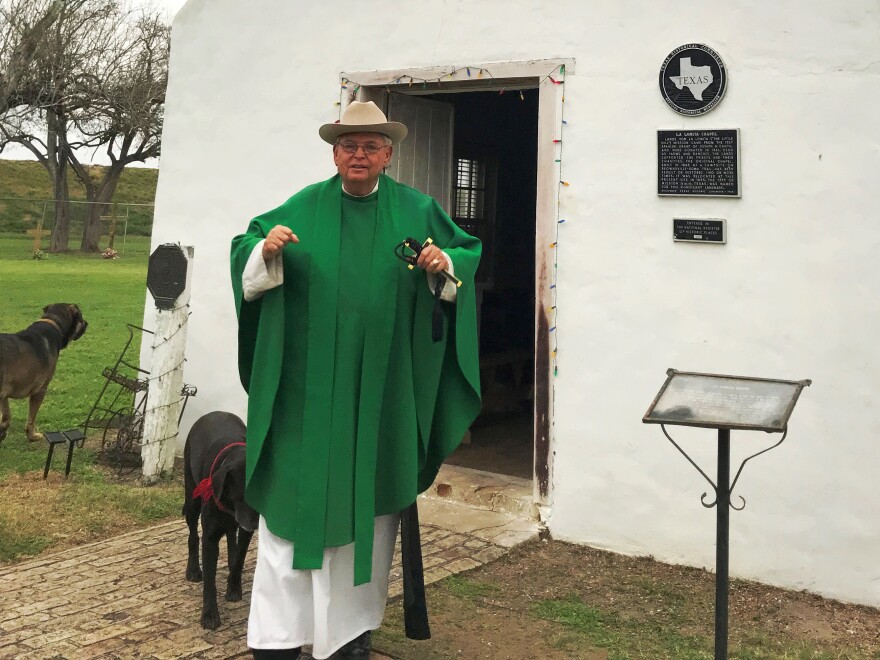 Father Roy Snipes with his dogs outside of La Lomita chapel.