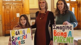 Lt. Gov. Suzanne Crouch poses with Tendra Duff and her 10-year-old daughter Kearsley on Jan. 29, 2024 in the Indiana Statehouse. The Duff family has 7-year-old twin boys, Trenin and Kaiden, who require 24/7 care that would be jeopardized by an FSSA proposal to curb attendant caregiver pay for parents.