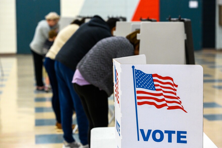 FILE: Voters fill out their ballots November 08, 2022, at the Manchester High School polling station.