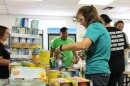 Volunteers for United Way carry canned vegetables as they sort through donations to the "Be Like Mike" Feeding the Keys event on Friday, May 17, 2024. Pantry operators say that it's community events like this one that help pantries stay stocked up as demand increases and access to quality food decreases.