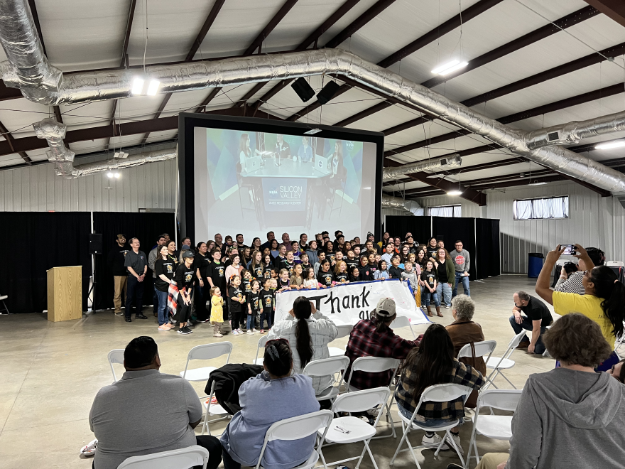 Students, teachers and volunteers at the event took a picture to thank Mann for answering their questions.