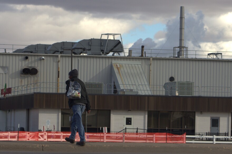 A Tyson employee crosses U.S. Highway 283 on Dec. 5 to start his shift at the meatpacking plant, which will close on Jan. 20, 2026.