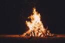 a bonfire lights up a night scene