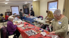 Volunteers at decorate goodie bags for Meals-on-Wheels recipients at Frederick County’s Senior Center.