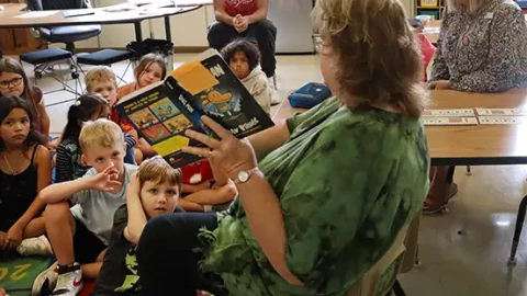Springfield Public School students listen to the reading of a book.