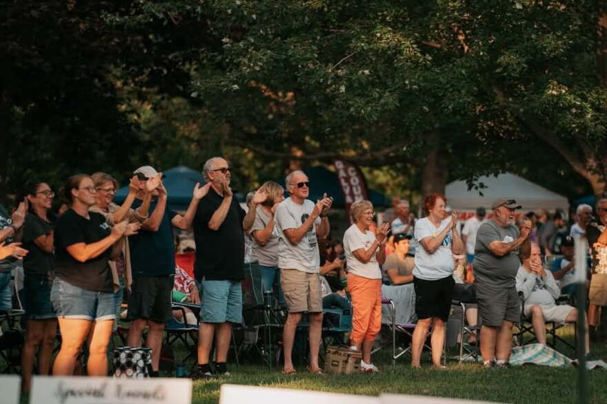 An audience shows appreciation at a concert of the Levitt AMP Galva summer music series.