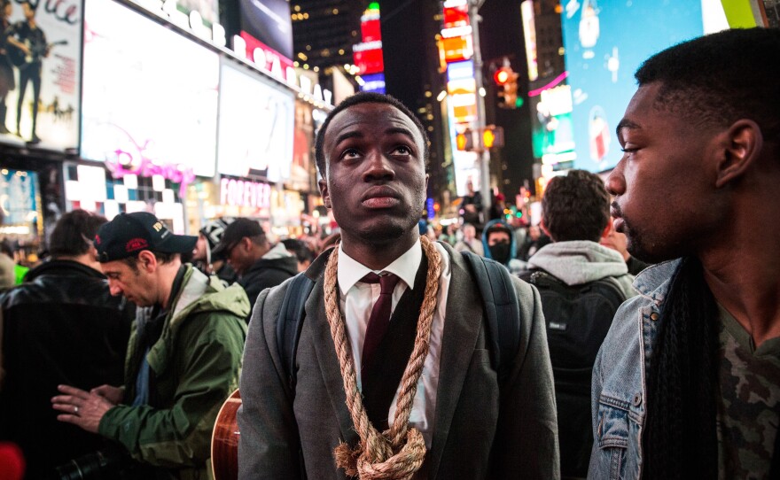 People protest Tuesday night in New York City's Times Square regarding the grand jury decision to not indict officer Darren Wilson in the Michael Brown case in Ferguson, Mo.