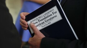 White House budget director Mick Mulvaney, holds a copy of "Budget of the U.S. Government A New Foundation For American Greatness Fiscal Year 2018" as he inspects the production run of President Donald Trump's fiscal 2018 federal budget, Friday, May 19, 2017, at the U.S. Government Publishing Office's (GPO) plant in Washington. (AP Photo/Carolyn Kaster)