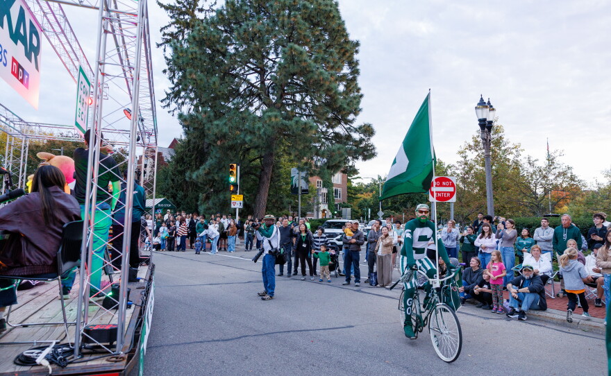 Johnny Spirit rides his bike along the Michigan State University Homecoming Parade route in East Lansing, Mich., on Oct. 9, 2026.
