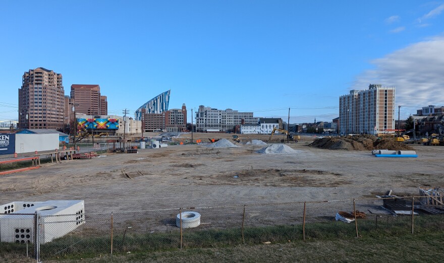 Undeveloped lots contain piles of dirt and construction equipment.