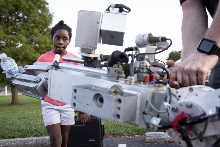 A young visitor checks out the EPD Bomb Squad robot at National Night Outs Tuesday night. Operator Mike Ward squirted children with water using the robot's arm.