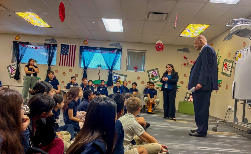 While introducing Horne, Principal Analisa Angulo explains the state superintendent's role to students.