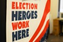 A closeup of a sign that reads "Election Heroes Work Here."