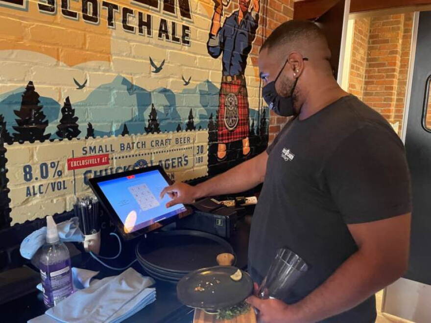 Server Lacey Crosby said he's happy to be working, despite the challenges.