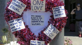 A heart-shaped wreath covered with positive messages hangs on a traffic light pole at a memorial for two bystanders who were stabbed to death Friday, while trying to stop a man who was yelling anti-Muslim slurs and acting aggressively toward two young women, including one wearing a Muslim head covering, on a light-trail train in Portland, Ore, Saturday, May 27, 2017. (Gillian Flaccus/AP)