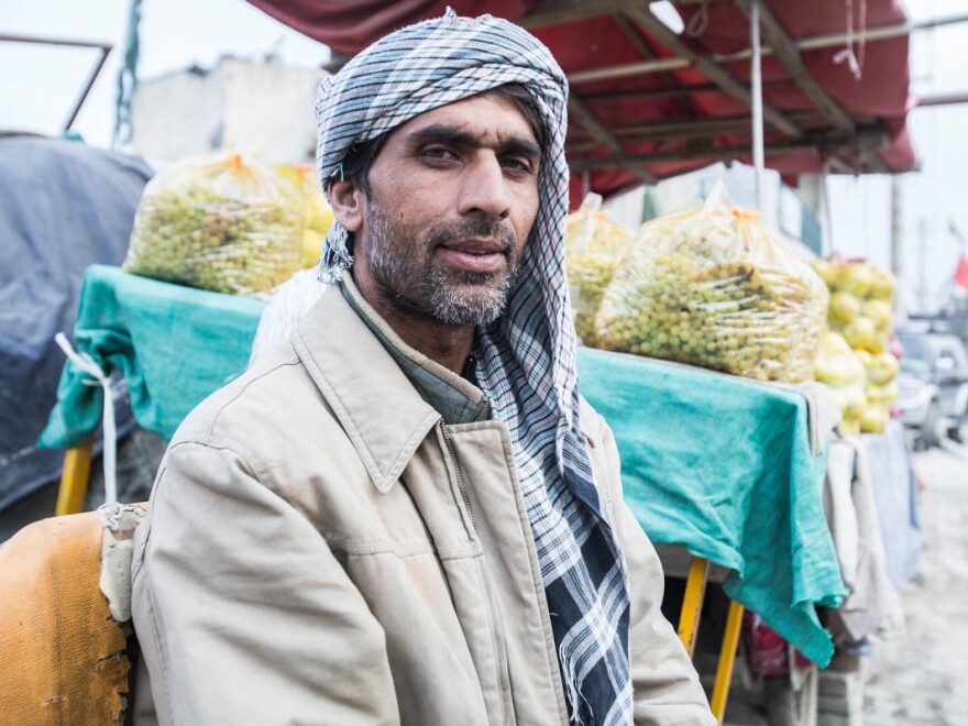 How is business? "Not good. ... Prices are high now. When we buy the fruits and vegetables at a high price, we have to sell them at a high price. And people don't buy when the prices are high. ... I don't have a job during the winter. Whatever I make now has to last for my family through the whole winter."