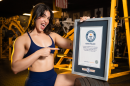 Lilian Zamora Alonso posing with the Guiness World Record certificate for heaviest weighted hip thrust by a woman.