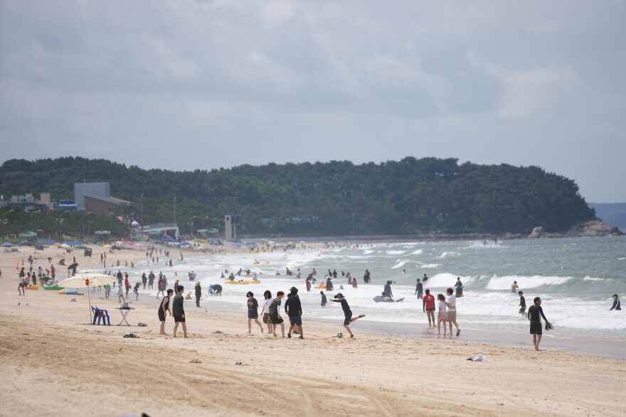 People enjoy a beach in Boryeong, South Korea, Saturday, July 25, 2026.
